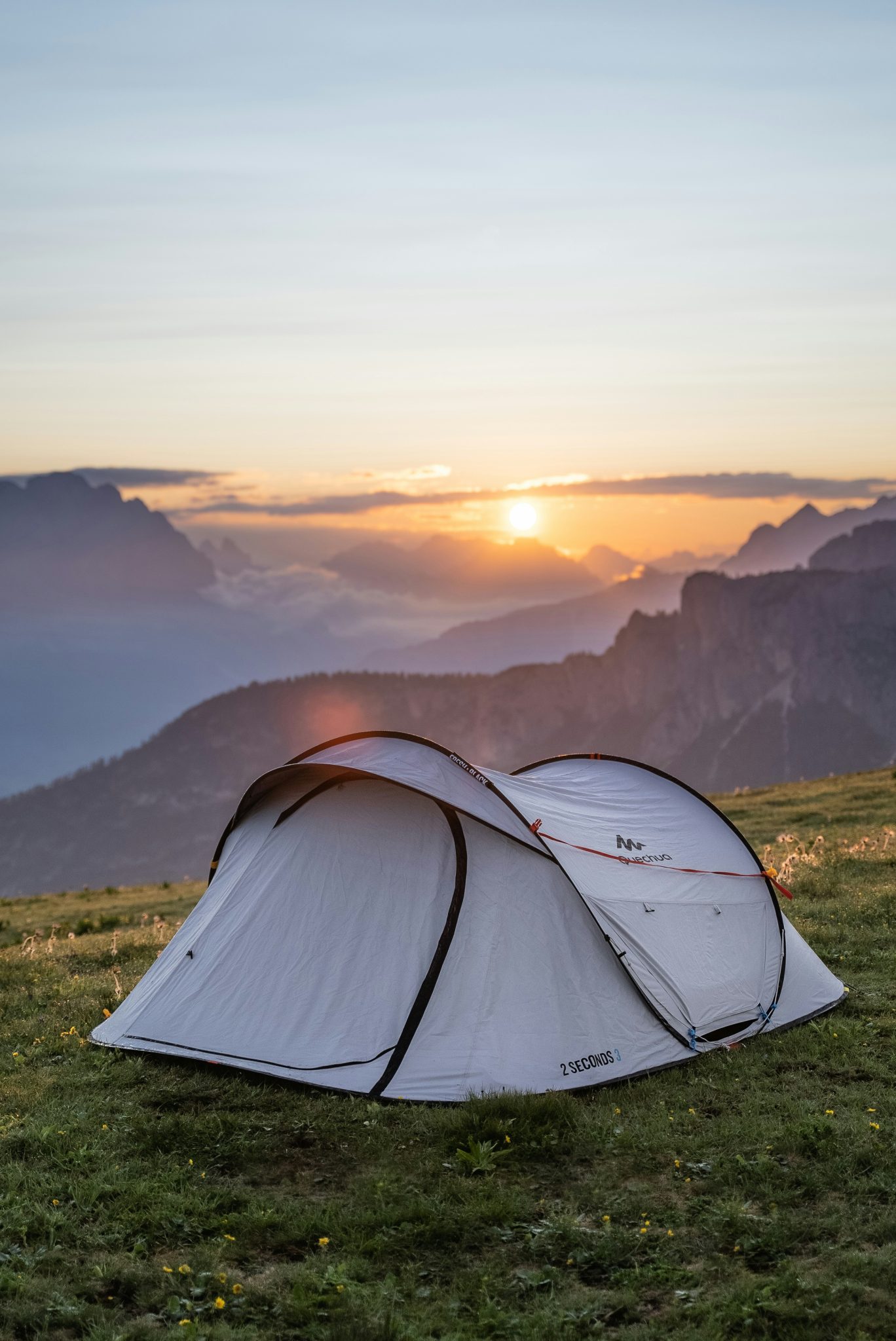 grantwriter for conservation a tent on a mountain top surrounded by beautiful skies and mountains